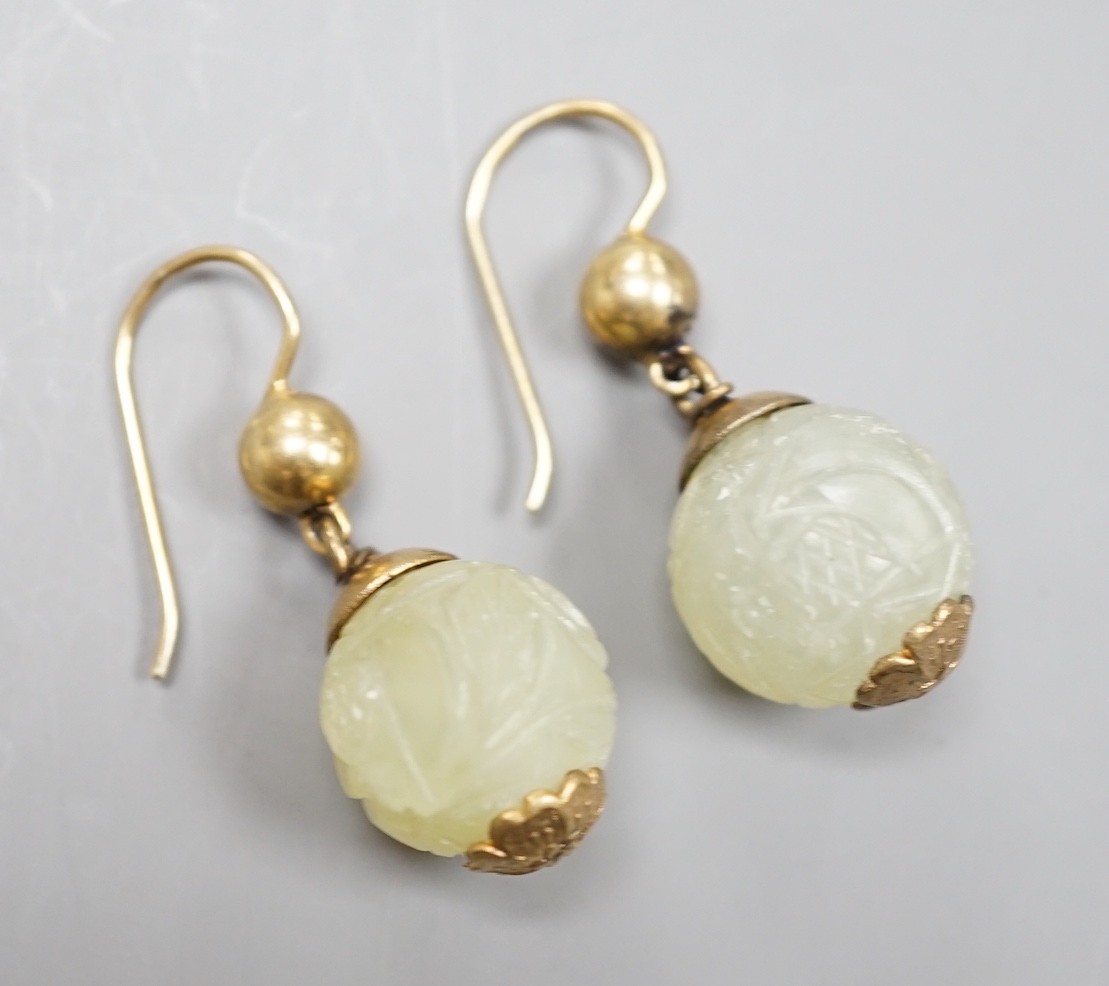 A pair of antique gilt metal and carved hardstone spherical drop earrings, jade diameter 14mm.